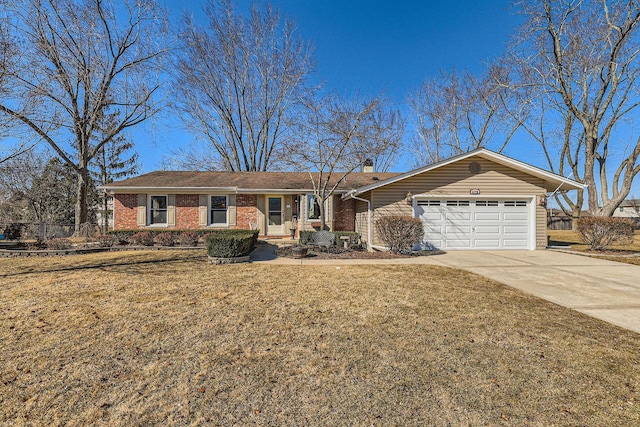 ranch-style house featuring concrete driveway, an attached garage, fence, a front yard, and brick siding