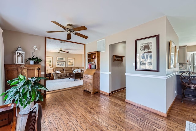 interior space featuring wood-type flooring, visible vents, and baseboards