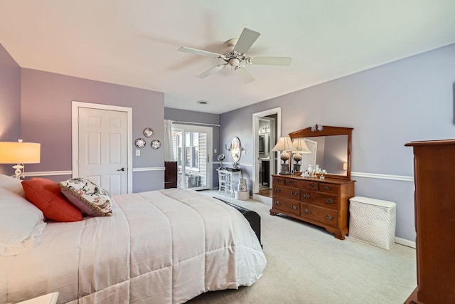 carpeted bedroom featuring a ceiling fan and baseboards