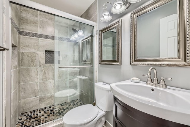 full bath with a shower stall, toilet, and vanity