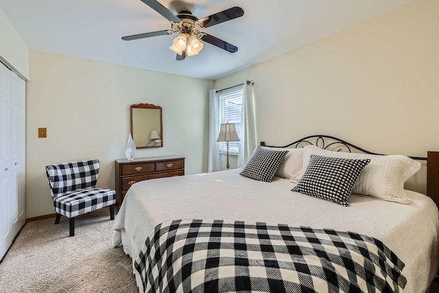 carpeted bedroom with a closet, ceiling fan, and baseboards