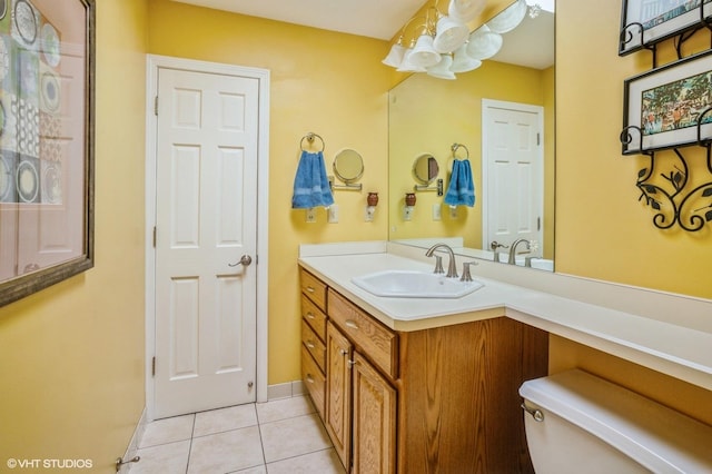 bathroom with baseboards, vanity, and tile patterned flooring