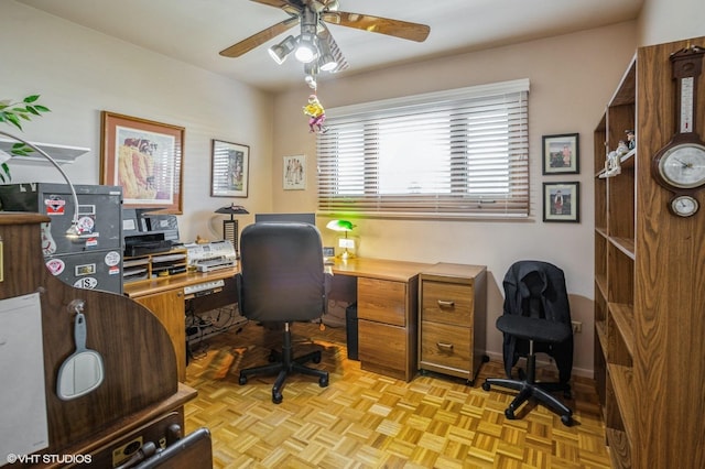 home office with baseboards and ceiling fan