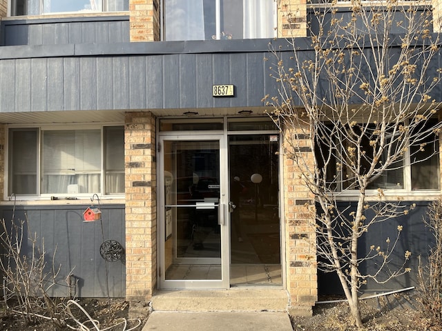 entrance to property with brick siding