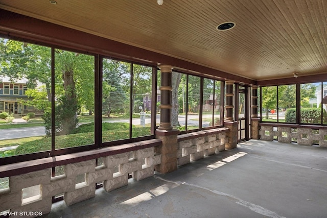 unfurnished sunroom featuring wooden ceiling