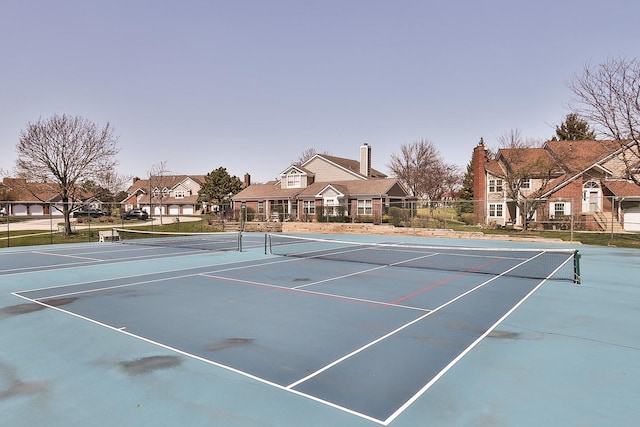 view of sport court with fence, a residential view, and community basketball court