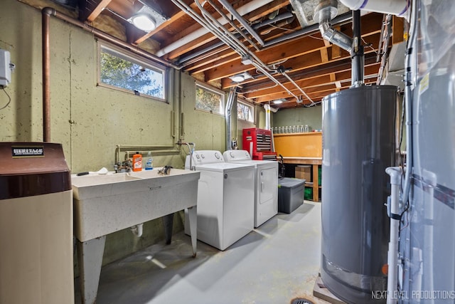 below grade area featuring water heater and washer and clothes dryer