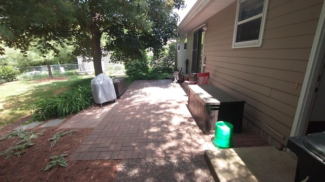 view of patio / terrace featuring a grill and fence