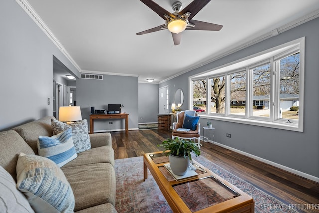 living room with visible vents, baseboards, ornamental molding, wood finished floors, and a ceiling fan