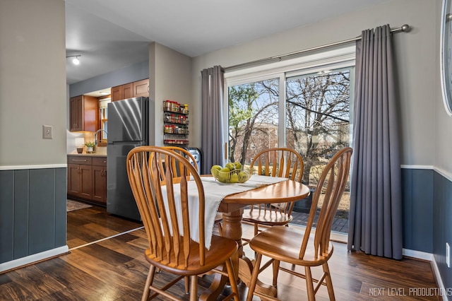 dining area featuring dark wood-type flooring