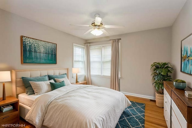6118 N Kimball Ave, Chicago, IL 60659 - bedroom with light wood-style floors, a ceiling fan, and baseboards