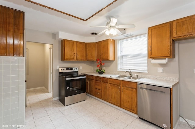 6118 N Kimball Ave, Chicago, IL 60659 - kitchen with ceiling fan, brown cabinets, a sink, light countertops, and stainless steel appliances