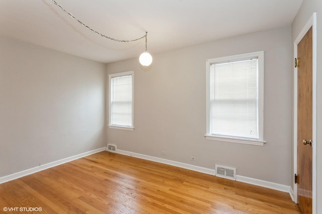 6118 N Kimball Ave, Chicago, IL 60659 - spare room with baseboards, visible vents, and light wood-style floors