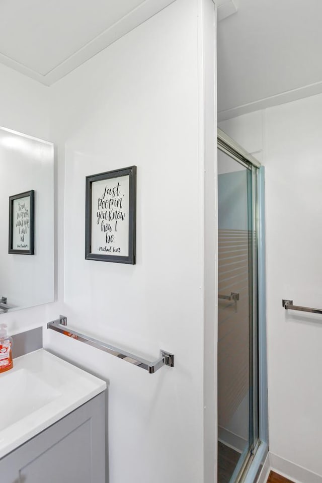 bathroom with a stall shower and vanity