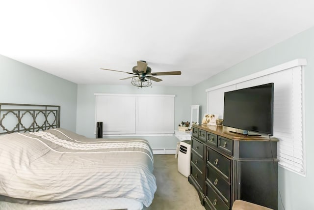 bedroom with light carpet, a baseboard heating unit, and a ceiling fan