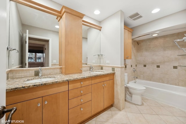 full bathroom with visible vents, a sink, tile walls, and tile patterned floors