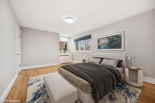 bedroom featuring light wood-style floors and baseboards