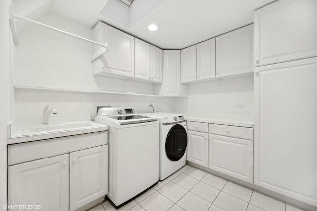 clothes washing area featuring cabinet space, light tile patterned floors, separate washer and dryer, a sink, and recessed lighting