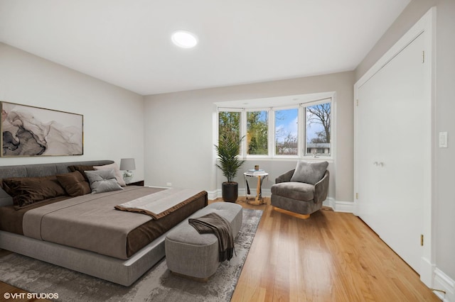 bedroom featuring baseboards and wood finished floors