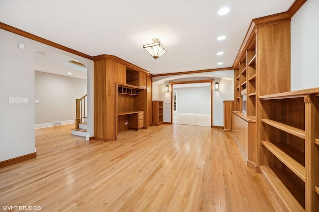 unfurnished living room with baseboards, arched walkways, stairway, crown molding, and light wood-type flooring