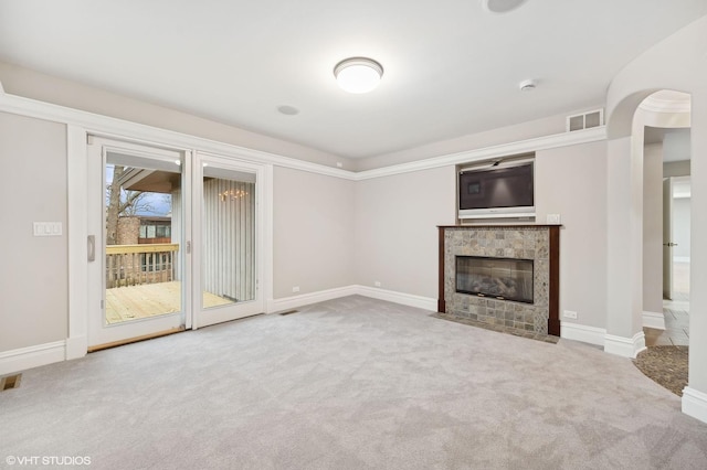 unfurnished living room featuring carpet floors, baseboards, visible vents, and a tiled fireplace