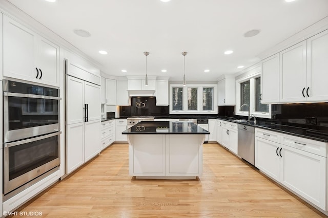 kitchen with stainless steel appliances, backsplash, and white cabinets