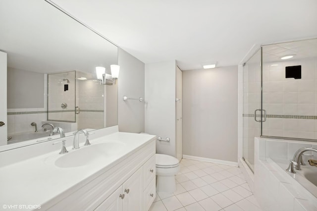 bathroom with a stall shower, baseboards, tile patterned floors, vanity, and a bath