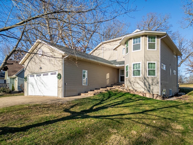 view of side of home featuring a garage, concrete driveway, and a lawn