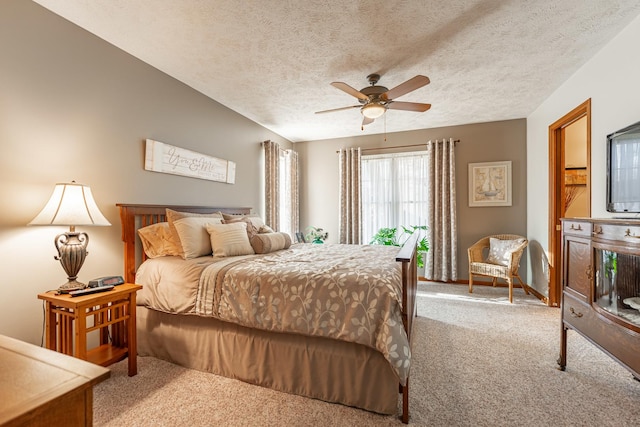 bedroom featuring carpet, ceiling fan, and a textured ceiling