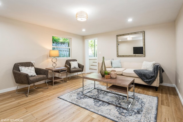 living room featuring baseboards, wood finished floors, and recessed lighting