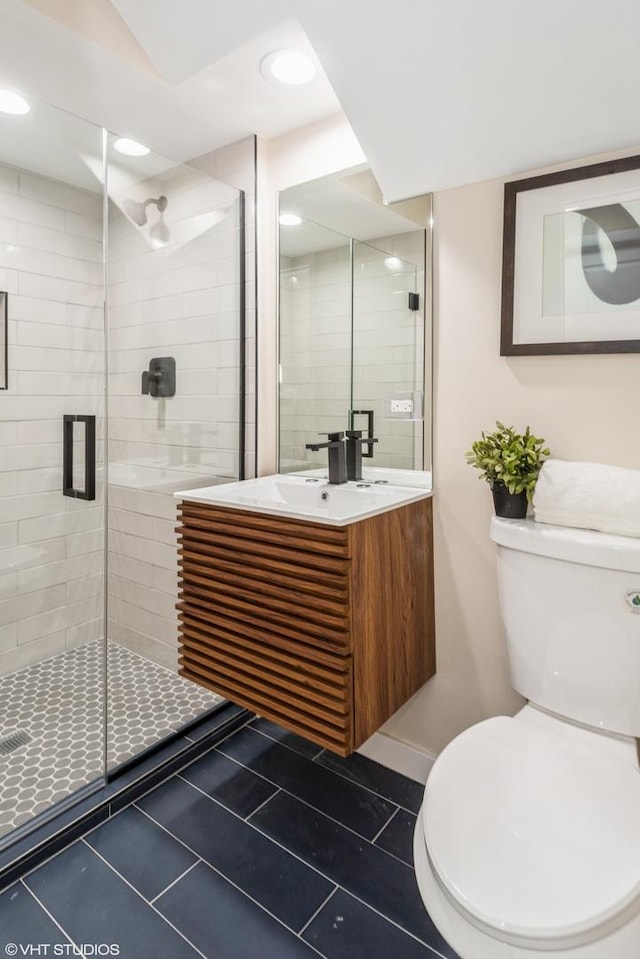 bathroom featuring recessed lighting, toilet, a stall shower, vanity, and tile patterned flooring