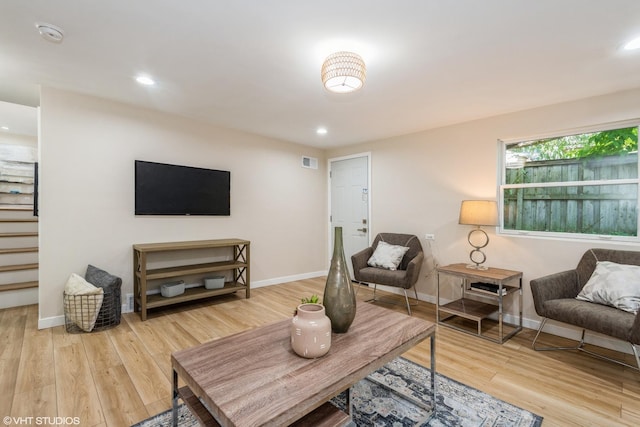 living room featuring recessed lighting, wood finished floors, visible vents, and baseboards