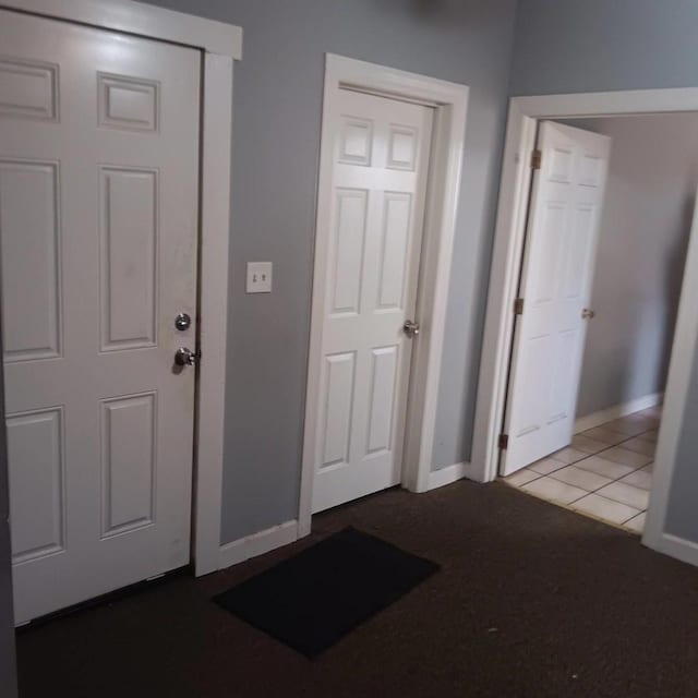 interior space with baseboards and tile patterned floors