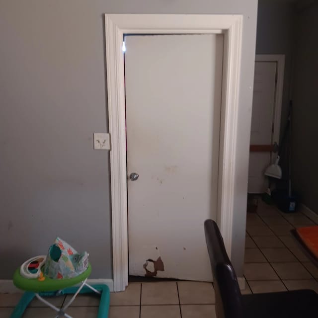 doorway to outside with light tile patterned floors