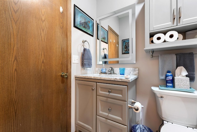 half bath with vanity and toilet