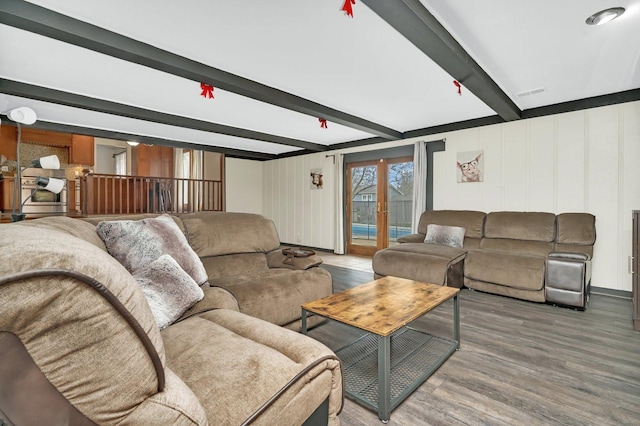 living area with visible vents, french doors, wood finished floors, and beam ceiling