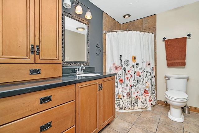 bathroom with curtained shower, vanity, toilet, and tile patterned floors