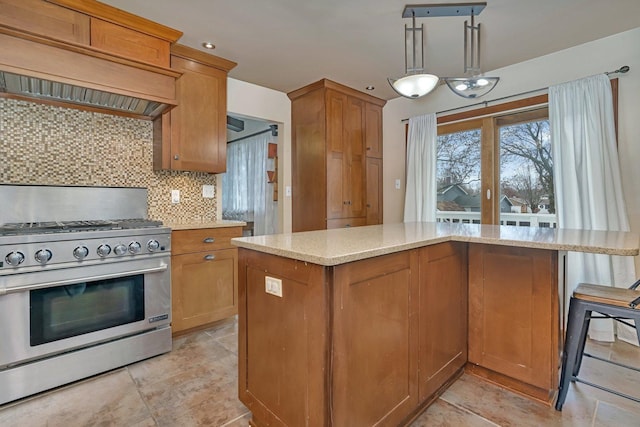 kitchen with light stone counters, a center island, decorative backsplash, stainless steel range with gas stovetop, and premium range hood