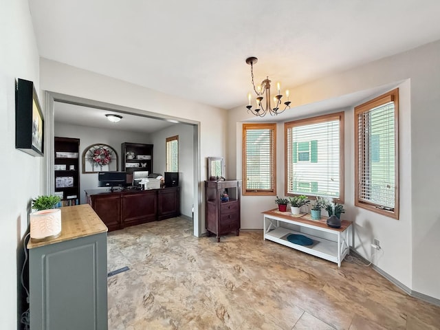 dining space with a chandelier and baseboards