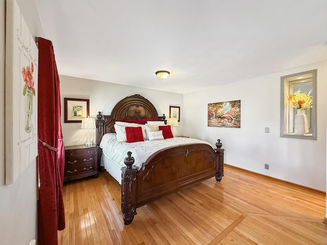 bedroom with light wood-style flooring and baseboards