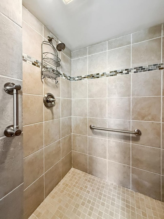 full bath with a tile shower