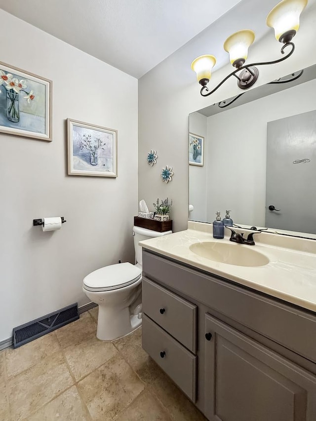 bathroom with toilet, baseboards, visible vents, and vanity