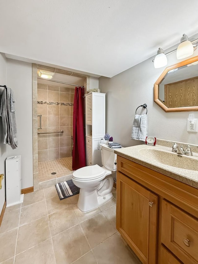 bathroom featuring vanity, tile patterned flooring, a shower stall, and toilet