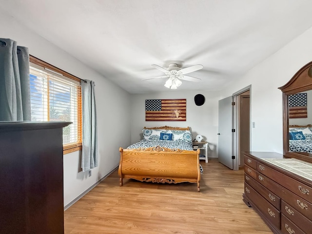 bedroom with ceiling fan and light wood-style flooring