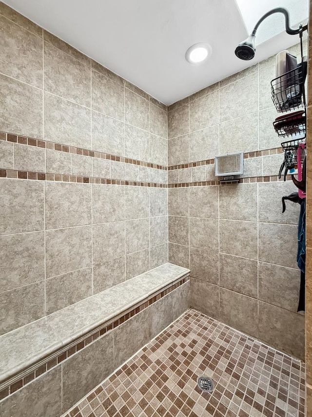 bathroom with a tile shower