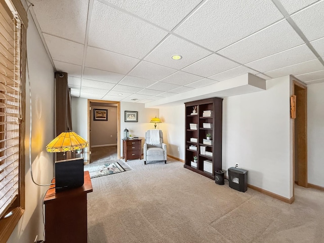 unfurnished room with carpet flooring, a paneled ceiling, and baseboards