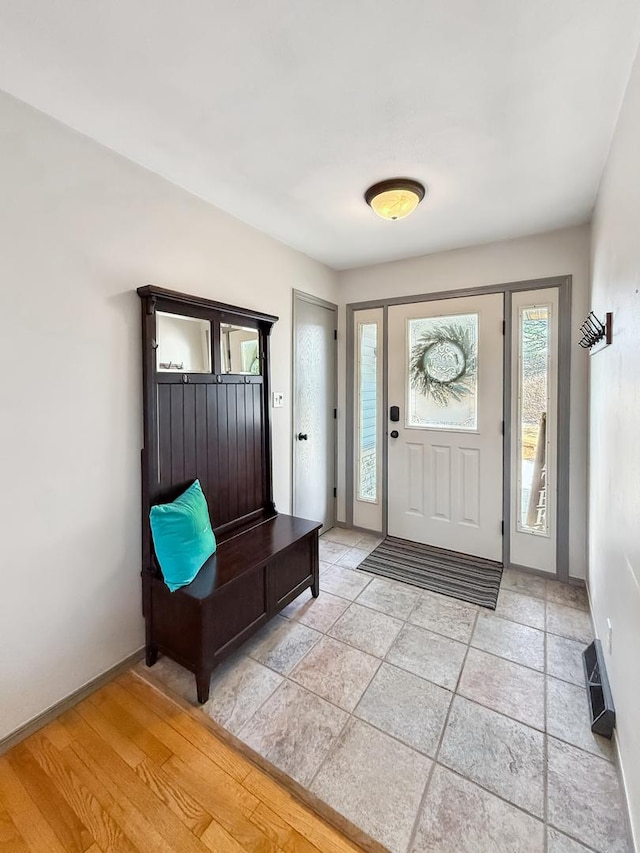 foyer featuring light wood-type flooring, visible vents, and baseboards