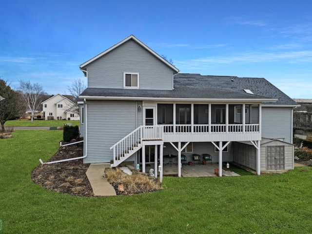 rear view of house with a yard, a patio, a sunroom, a shed, and an outdoor structure