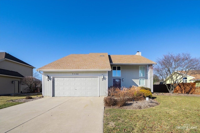 view of front facade with a front lawn, fence, concrete driveway, a garage, and a chimney