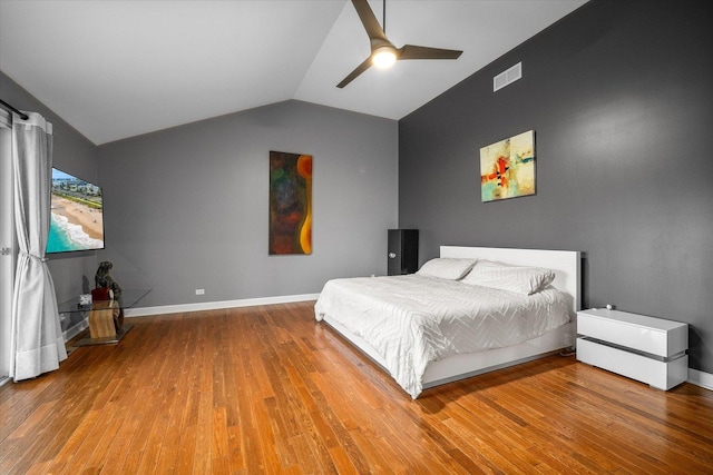 bedroom with baseboards, wood finished floors, a ceiling fan, and vaulted ceiling